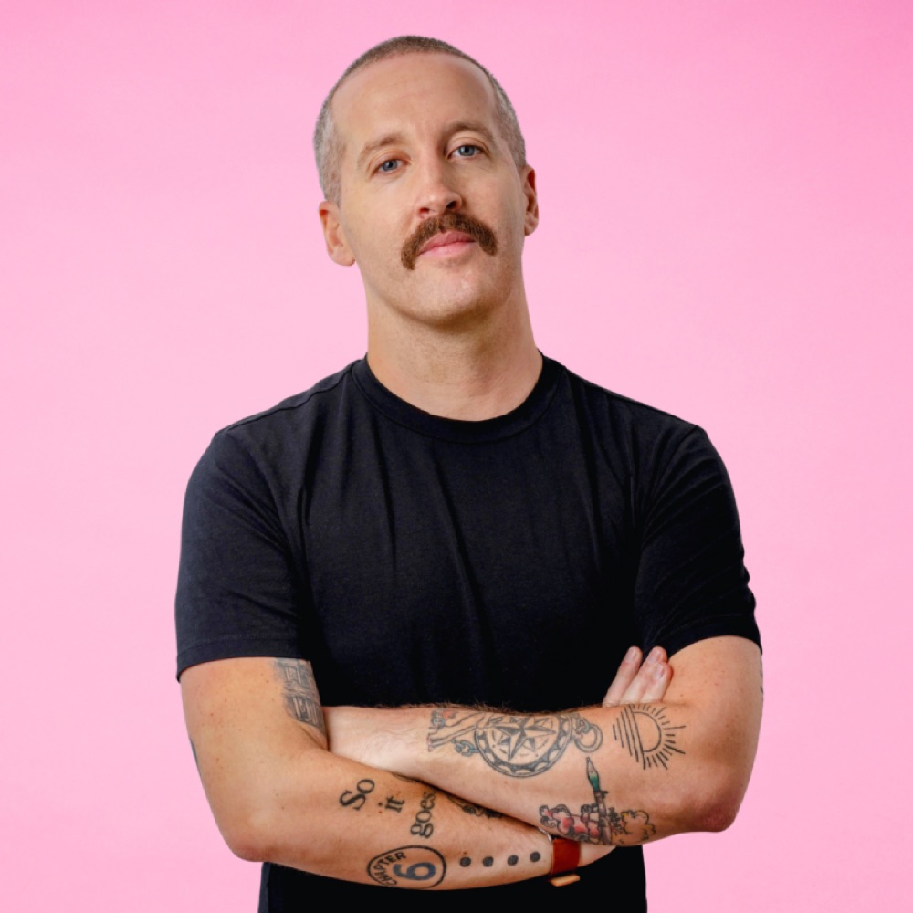 Portrait of Conor Walsh against a pink background
